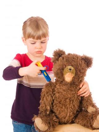 girl giving vaccine to her teddy bear